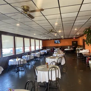 tables and chairs with white tablecloths