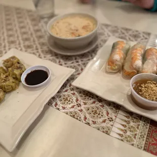 two plates of food and a bowl of dipping sauce