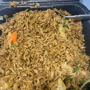 rice and vegetables in a black container