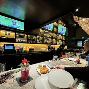 two people sitting at a bar