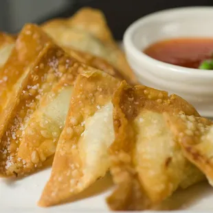 a plate of fried food with dipping sauce