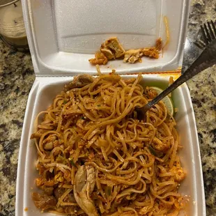 a container of noodles and a fork