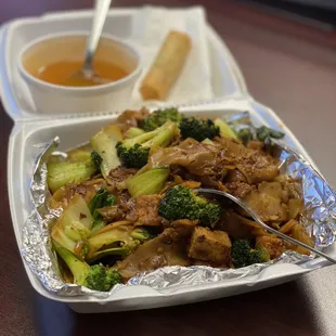 Lunch special (to-go order) of Pad See Ew with tofu. Specials come with delicious soup and one vegetarian egg roll.