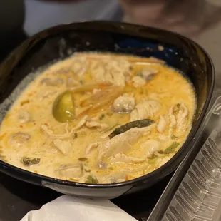 a bowl of soup and a plastic container