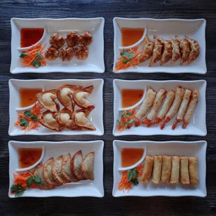 a variety of appetizers arranged in square dishes