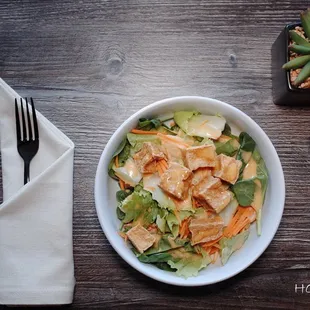 a bowl of salad and a fork