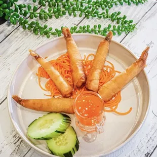 Shrimp wrapped in rice paper, deep-fried servedwith sweet and sour sauce