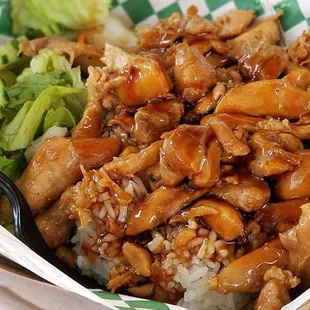 chicken and rice in a basket with chopsticks