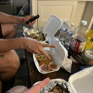 two people sitting at a table with food