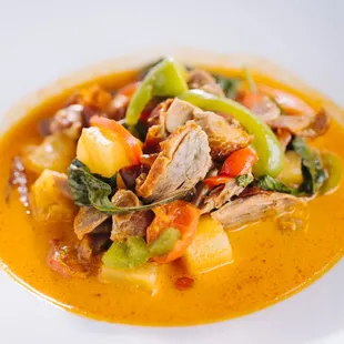 a bowl of soup with meat and vegetables