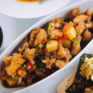 a dish of food with a side of rice