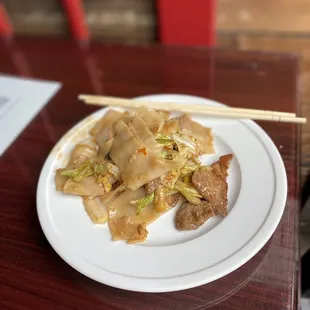 a plate of food with chopsticks