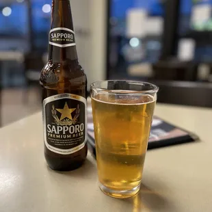 a glass of beer and a bottle