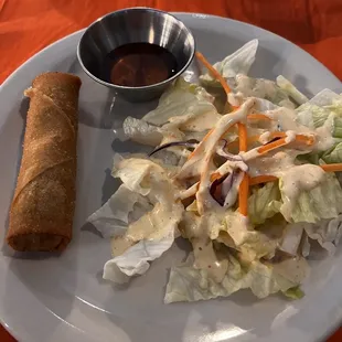 Egg roll and salad served before soup.