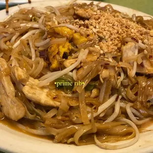 a plate of noodles with meat and vegetables