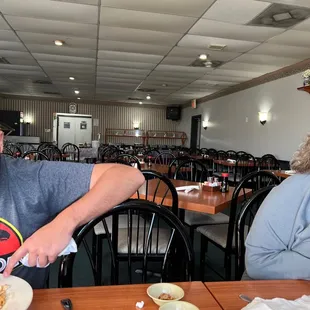 a man sitting at a table with a plate of food