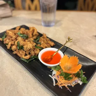 a plate of fried food with dipping sauce
