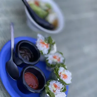 a plate of sushi and sauces