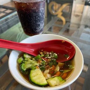 a bowl of soup and a drink