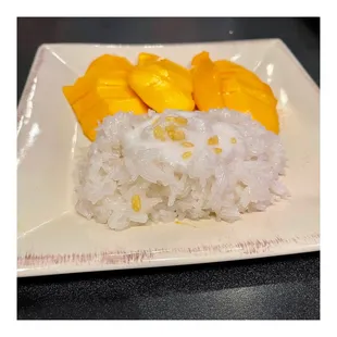 a plate of rice and mangos