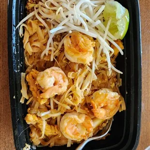 shrimp and noodles in a black bowl