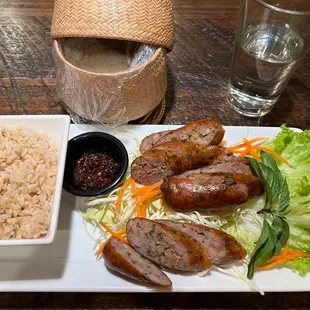 a plate of rice, meat, and vegetables