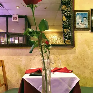 a vase with a single rose in it