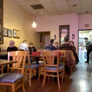 people sitting at tables in a restaurant