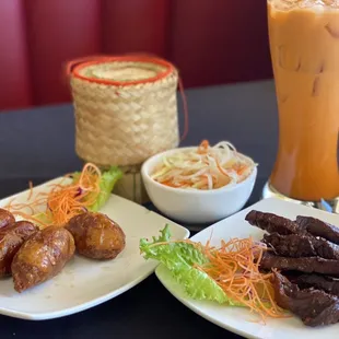 Sticky rice, thai ice tea, papaya salad, Thai sausage