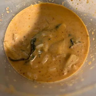 a spoon in a bowl of soup