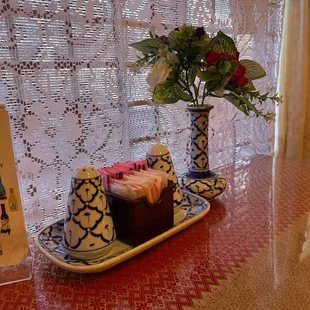 a tray of food and a vase of flowers