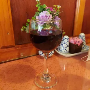 a glass of wine and a plate of desserts