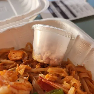 a container of noodles and shrimp
