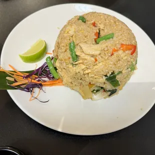 a plate of fried rice and vegetables