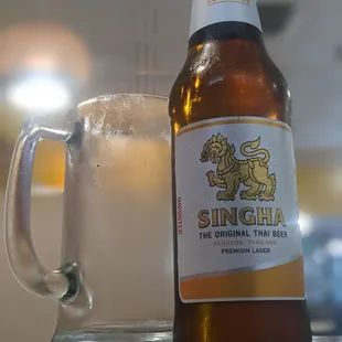 a glass of beer next to a beer bottle