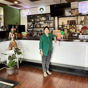 a woman standing in front of a bar