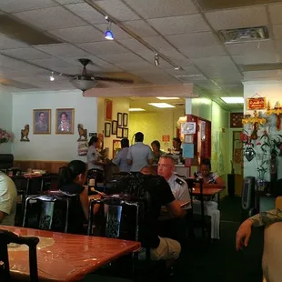 people sitting at tables in a restaurant