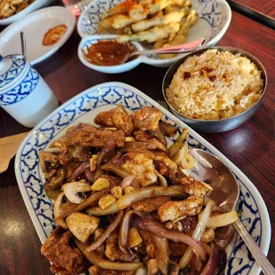 Moo Gra Tiem at Thai Paradise Pickerington is a flavorful dish containing crispy garlic pork, white onions, and black pepper sauce,