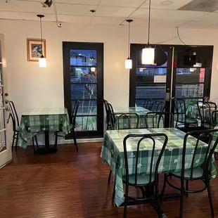 tables and chairs with green tablecloths