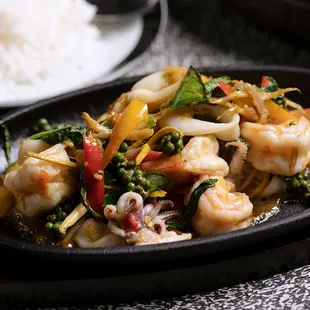 a plate of shrimp and vegetables with rice