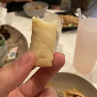 a person holding a piece of food