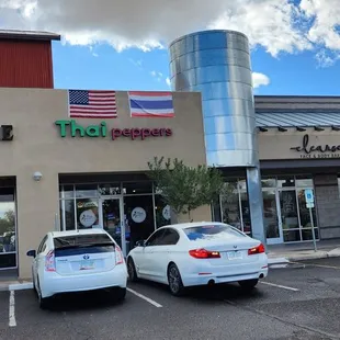 two cars parked in front of the restaurant