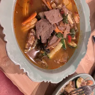 a bowl of beef and vegetable soup