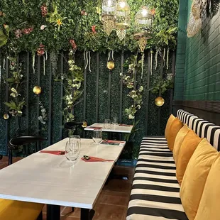 a dining area with a green wall