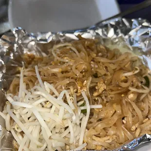 a plate of noodles and meat