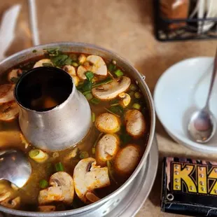 a bowl of soup and a spoon on a table