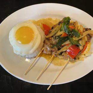 Thai basil Pork Skewers with side of jasmine rice and Fried Egg on top.