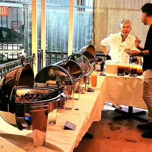 a group of people standing around a buffet table