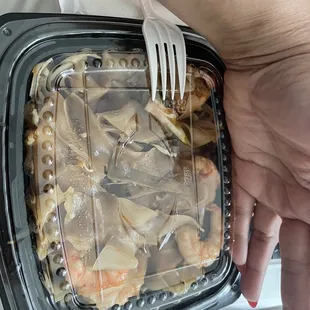 Hand in photo for size reference. Drunken Noodles With shrimp.