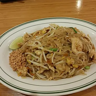 a plate of noodles with meat and vegetables